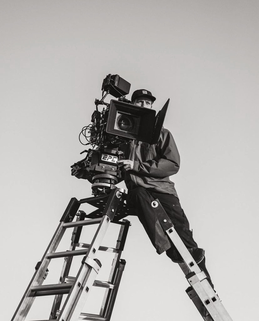 Robin Asselmeyer operating a cinema camera from the top of a ladder