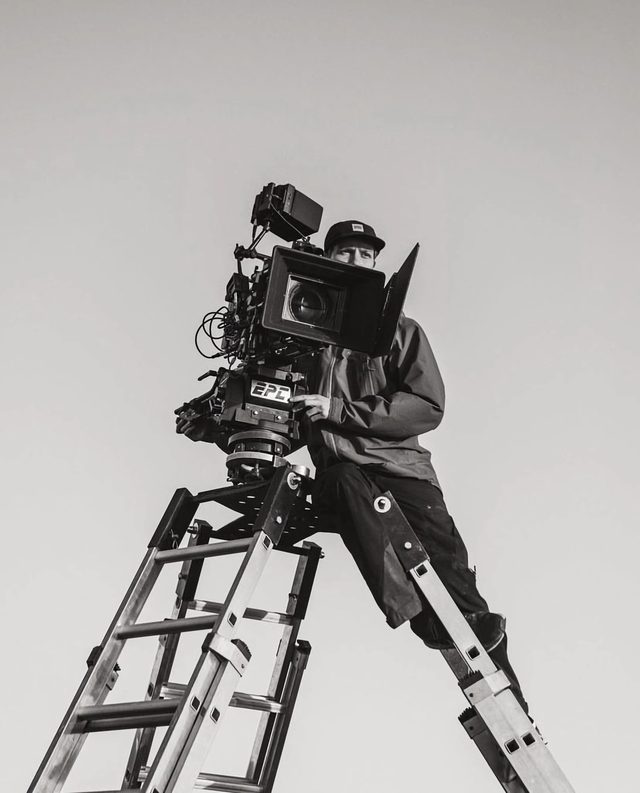Robin Asselmeyer operating a cinema camera from the top of a ladder